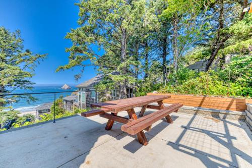 a wooden picnic table on a patio overlooking the ocean at Oceanside Skies in Oceanside