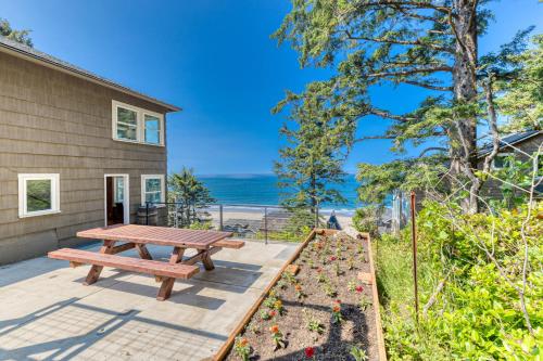 a picnic table on a patio with a view of the ocean at Oceanside Skies in Oceanside