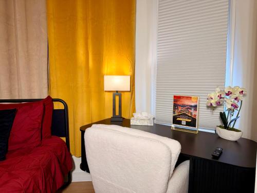a bedroom with a desk with a chair and a lamp at Hotel-Style, No Host, Professionally Managed ID247 in Jersey City