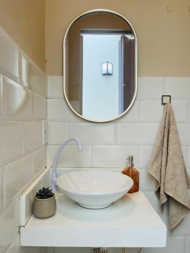 a bathroom with a white sink and a mirror at Casa Urban 56 - Pet Friendly - Vaga - Cama King in Belém