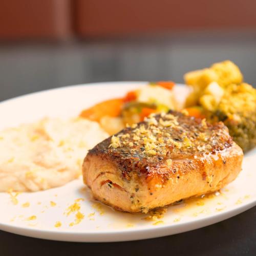 a plate of food with a piece of meat and vegetables at Ibis Styles SP Centro in Sao Paulo