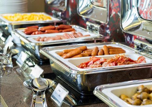 a buffet with several trays of different types of food at Zlatibor Royal Green in Zlatibor