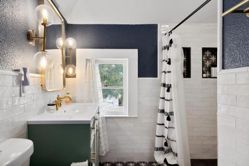a bathroom with a sink and a shower at Ellie Marie House in Seguin