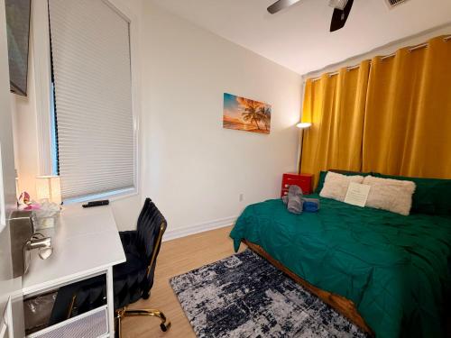 a bedroom with a green bed and a desk at Hotel-Style, No Host, Professionally Managed ID247 in Jersey City