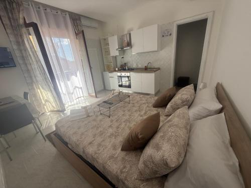 a bedroom with a large bed with pillows on it at Home Sorrento in Torre del Greco