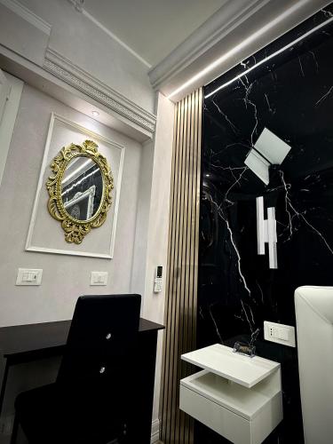 a bathroom with a sink and a mirror on the wall at Suite Rooms Empire in Tropea