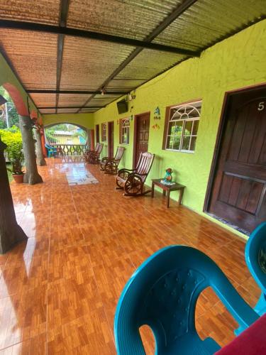 a large room with chairs and a wooden floor at Casa Caimana in Moyogalpa