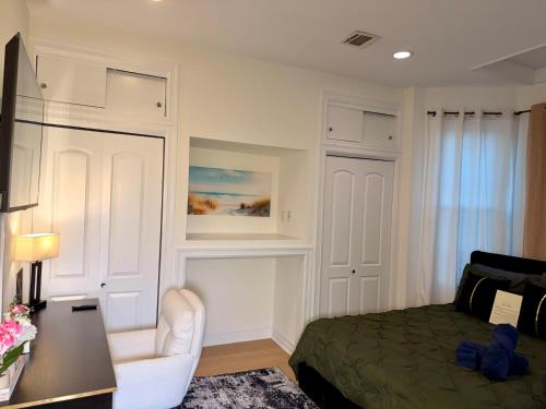 a bedroom with a bed and a chair and a desk at Hotel-Style, No Host, Professionally Managed ID247 in Jersey City