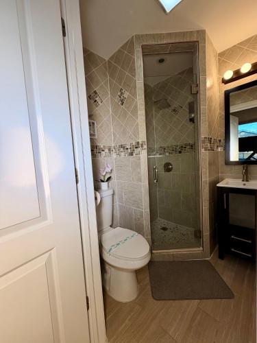 a bathroom with a toilet and a shower and a sink at Hotel-Style, No Host, Professionally Managed ID247 in Jersey City