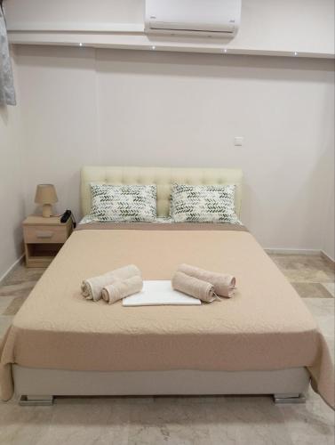 a bedroom with a large bed with two pillows at Elia patra apartment in Patra