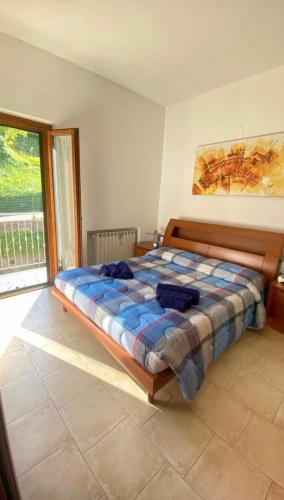 a bedroom with a bed in a room with a window at Appartamento da Mery in Asso