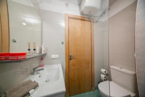 a bathroom with a tub and a toilet and a sink at Stylish Apartment with Pool Adan Beach Aourir in Aourir