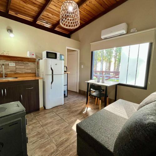 a kitchen with a refrigerator and a table in a room at Olivos de Monte in San Miguel del Monte