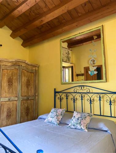 a bedroom with a bed with a large mirror at Il Giardino di Athena vista Valle dei Templi in Villaggio Peruzzo