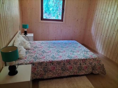 a small bedroom with a bed and a window at Private Pool Douro River View Villa in Covelas