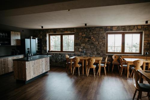 a kitchen and dining room with a table and chairs at eM Apartments Javorník in Vacov