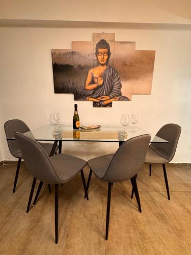 a dining table with chairs and a painting on the wall at Brisa Marina in Grao de Castellón