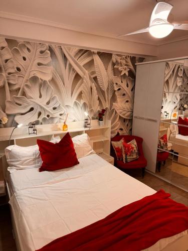 a bedroom with a large white bed with red pillows at Brisa Marina in Grao de Castellón