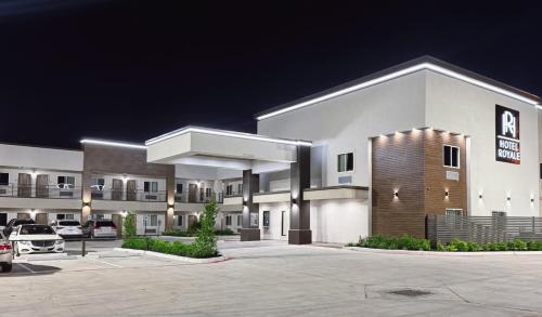 a parking lot in front of a hotel at Hotel Royale - Houston Hobby Airport in Houston