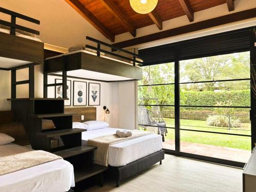 a bedroom with two beds and a large window at exclusive villa - private pool, luxury and comfort in Armenia