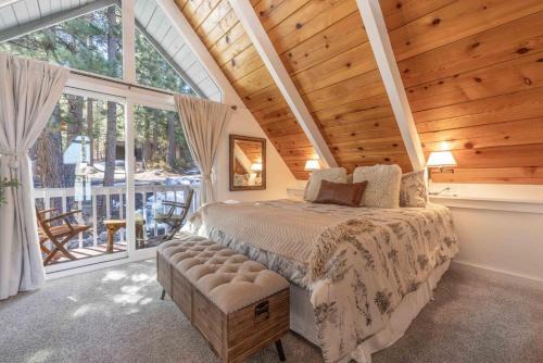 a bedroom with a bed and a large window at Cove Lakeside Jacuzzi, Central AC, Stunning View in Big Bear Lake