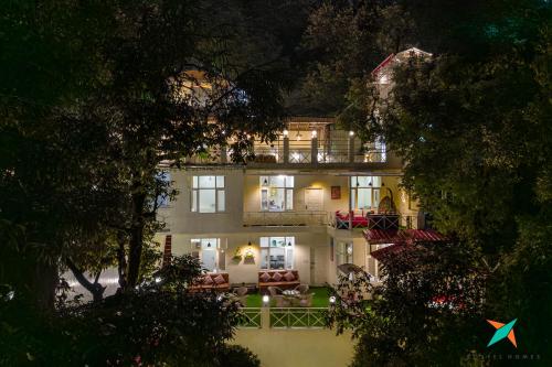 a large white house at night with lights at Zostel Homes Mussoorie in Mussoorie