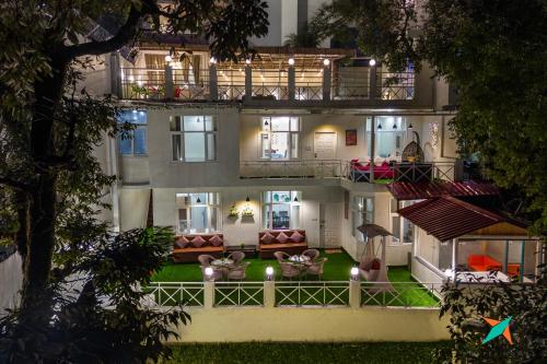 a building with a lot of furniture in the yard at Zostel Homes Mussoorie in Mussoorie