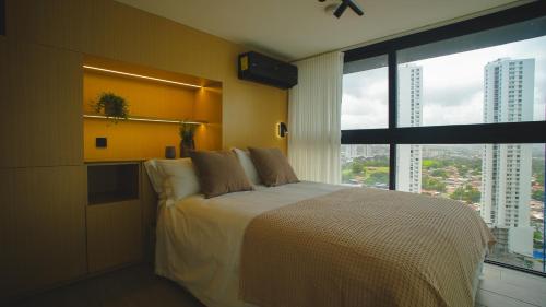 a bedroom with a bed and a large window at Dovle Branded Residences by HMS in Panama City