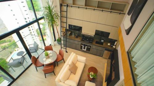 an overhead view of a living room with a table and chairs at Dovle Branded Residences by HMS in Panama City