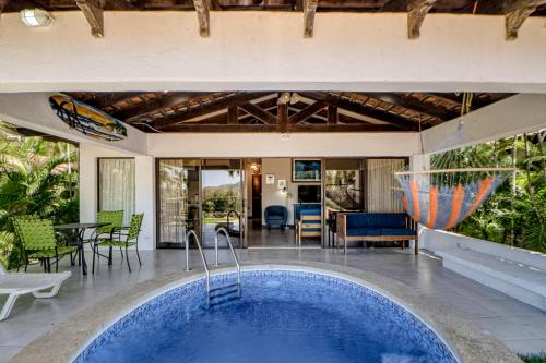 an indoor swimming pool in a house with a patio at Villa Sol 35 in Playa Hermosa
