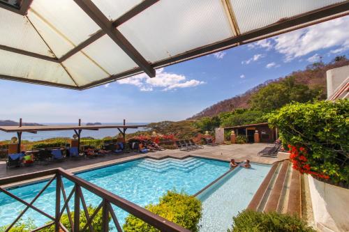 a view of a swimming pool from a balcony at Villa Sol 35 in Playa Hermosa