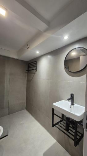 a bathroom with a sink and a mirror on the wall at 1902Aparts in Montevideo