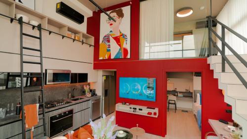 a living room with a red wall and a kitchen at Dovle Branded Residences by HMS in Panama City