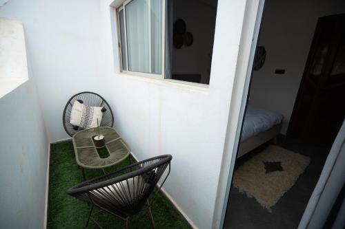 a small room with a table and a chair at Ocean Charm in Tamraght Ouzdar