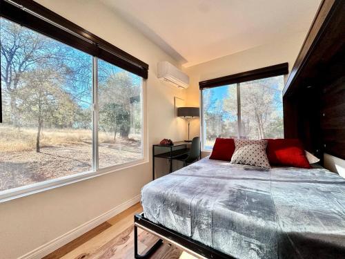a bedroom with a bed and a large window at Unique Container, Home 20 Acres, Modern Stay in Kelsey
