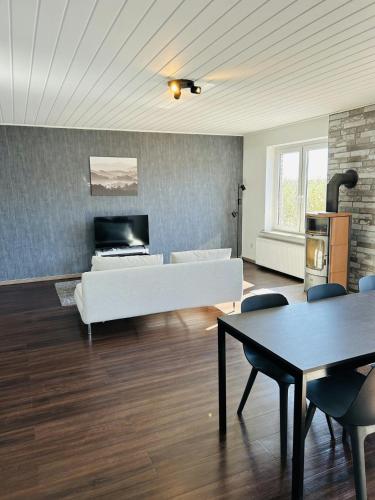 a living room with a white couch and a fireplace at Spacious Apartment for 6 in Bobitz