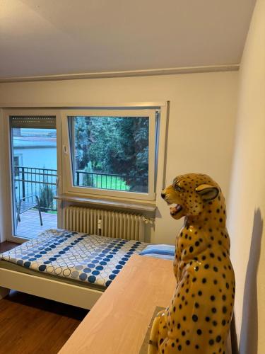 a stuffed dog sitting on a bed in a room at Monteur- und Ferienwohnung Rheinhausen - Lönsweg in Oberhausen-Rheinhausen