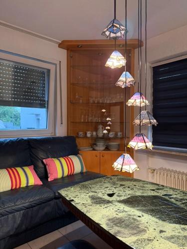 a living room with a couch and a table at Monteur- und Ferienwohnung Rheinhausen - Lönsweg in Oberhausen-Rheinhausen
