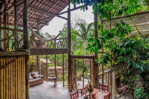 an outside view of a house with trees and plants at Casa Aviari in Cabo Matapalo