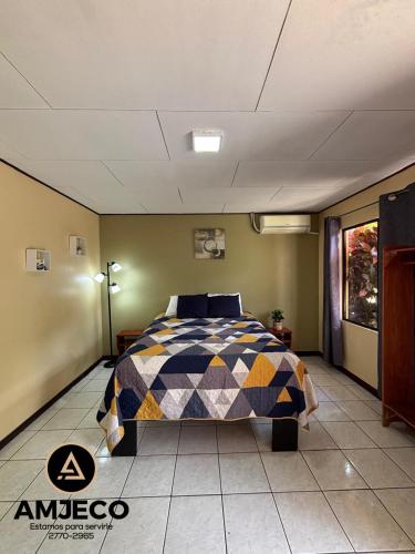 a bedroom with a bed in a room at Hotel Amjeco in San Isidro