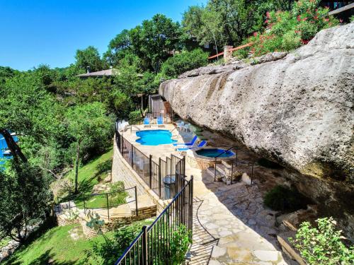 a resort with a rock wall and a swimming pool at Lakefront Bungalow with Community PoolHot Tub #5 in Lakeway