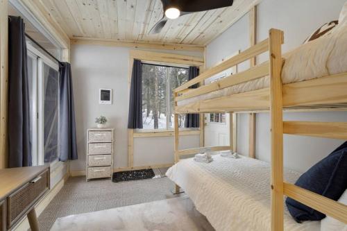 a bedroom with bunk beds in a tiny house at The Tyrolean Cabin. Panoramic Views. Hot Tub. in Wondervu