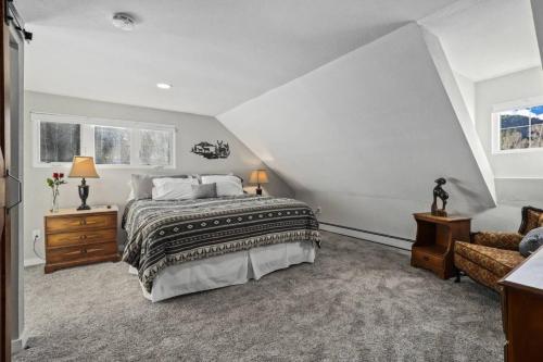 a bedroom with a large bed and a couch at Cabin by North Clear Creek. Private Hot Tub. Pets in Central City