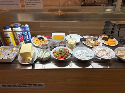 a buffet with many plates of food on a counter at Voula Hotel in Hersonissos