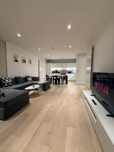 a living room with a couch and a dining room at Luxury 2 Bedroom 2 Bathroom Apartment by ExCeL & The 02, London in London