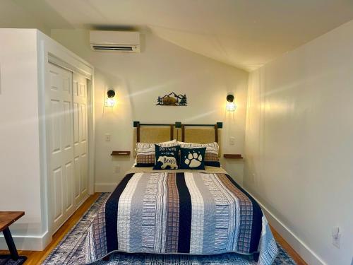 a bedroom with a bed with a striped comforter at Beary Cozy in Fairview