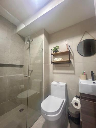 a bathroom with a shower and a toilet and a sink at New modern apartment in Barranquilla