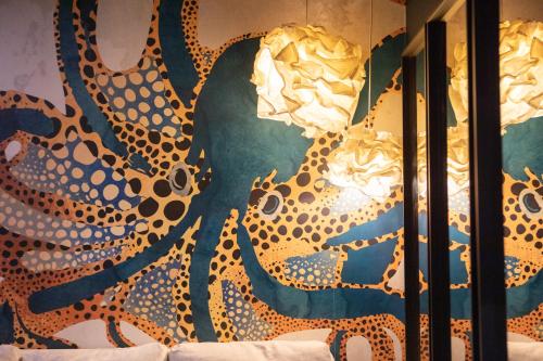 a wall with a painting of a leopard at Japan Universe Spa & Arcade in Mulhouse