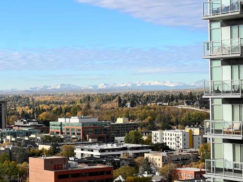 a view of a city with mountains in the background at 2Bed DT-Mountain & Skyline Views- Colours 1st-BMO in Calgary