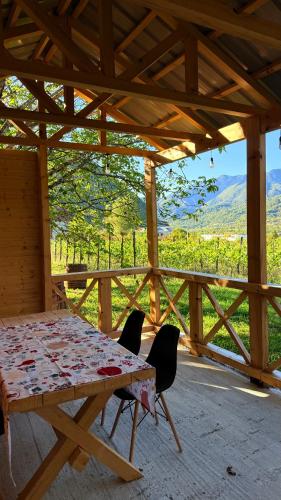 a table and chairs in a pavilion with a view of a mountain at Rachuli blendi in Ambrolauri